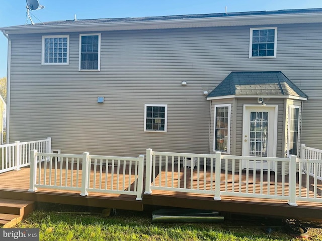 back of property with a wooden deck