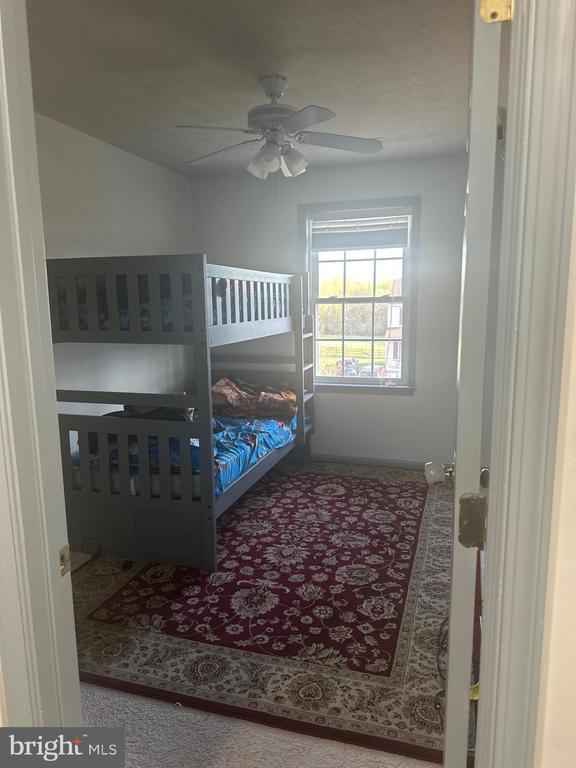 bedroom featuring a ceiling fan and baseboards