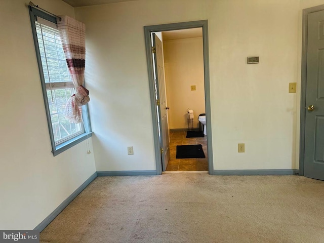 interior space with carpet floors and baseboards