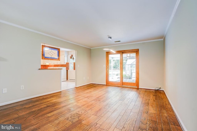  - spare room featuring wood finished floors and ornamental molding