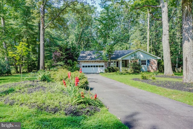  - single story home featuring driveway and an attached garage