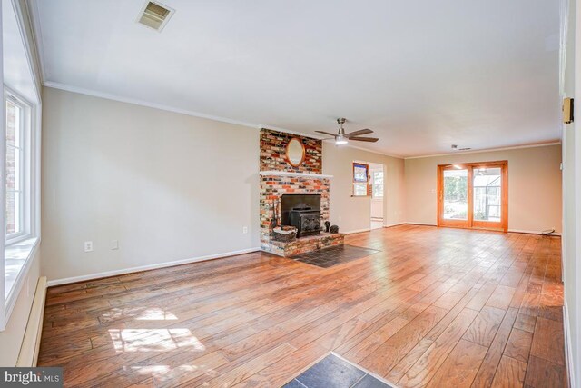  - unfurnished living room with a ceiling fan, wood-type flooring, and ornamental molding