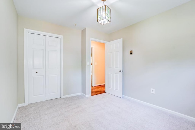  - unfurnished bedroom featuring carpet flooring and a closet