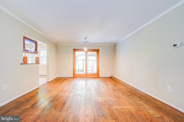  - spare room featuring wood finished floors and ornamental molding