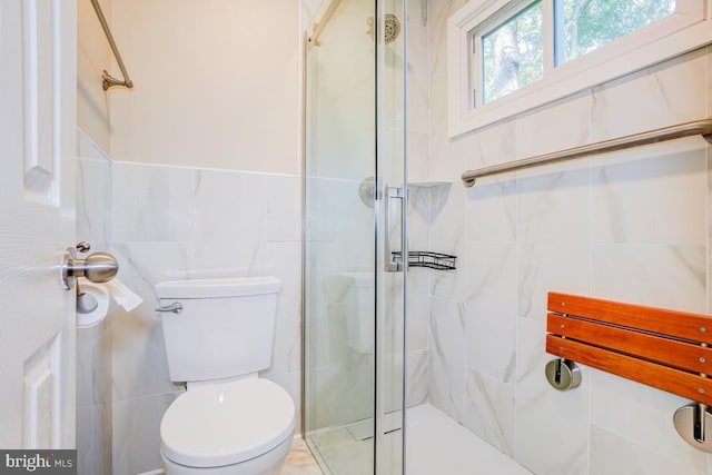  - full bath featuring tile walls and a shower stall