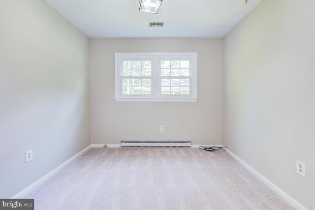  - carpeted spare room featuring a baseboard radiator and baseboards