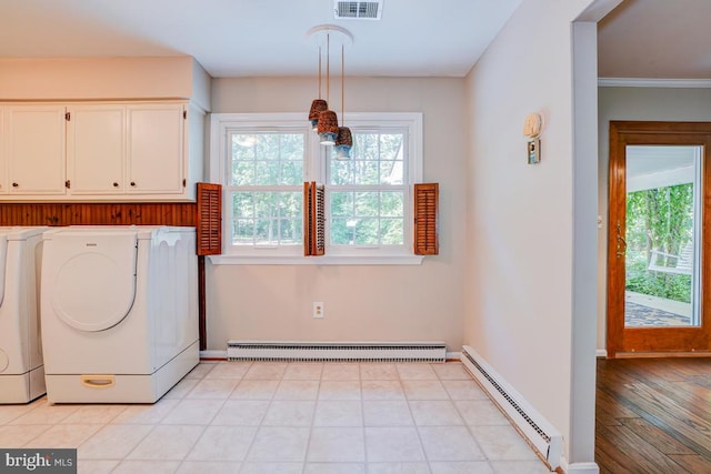  - washroom with a baseboard radiator, washing machine and dryer, and cabinet space