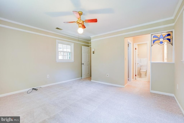  - spare room with crown molding, a ceiling fan, and light carpet
