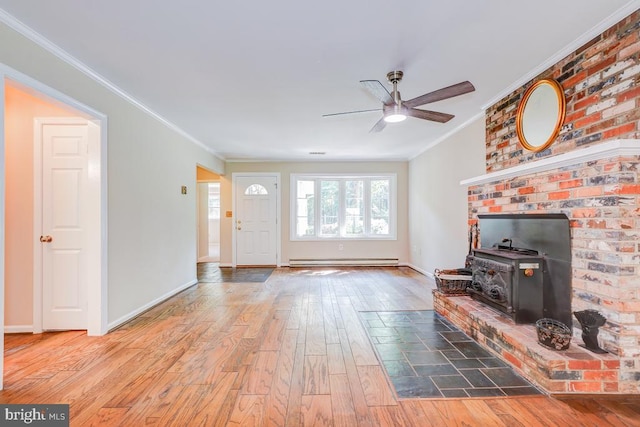  - unfurnished living room with a baseboard radiator, wood-type flooring, ceiling fan, ornamental molding, and a wood stove