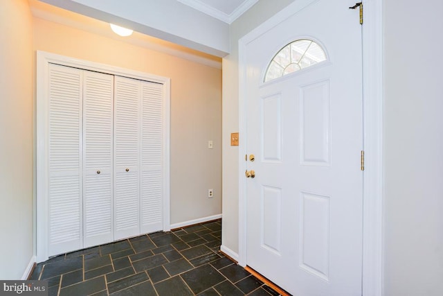  - entryway with crown molding and dark stone finish floors