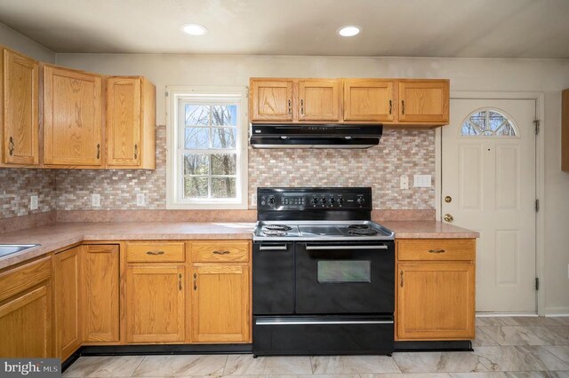 8128 Shirley Rd, Spotsylvania, VA 22551 - kitchen featuring range hood, black electric range oven, healthy amount of natural light, and light countertops