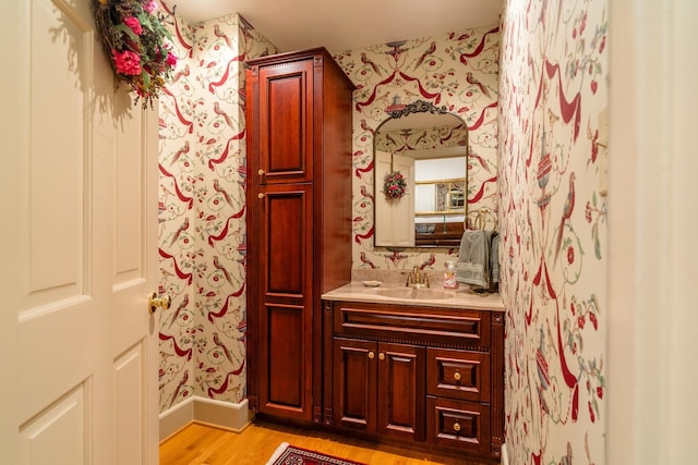 16540 Stoney Lea Ln, Elkton, VA 22827 - bathroom featuring wallpapered walls, wood finished floors, and vanity