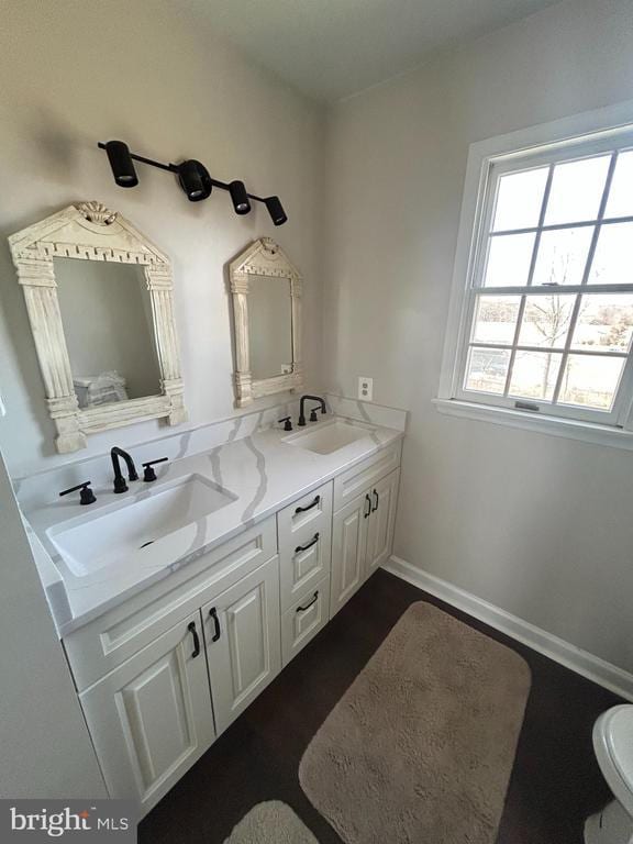  - full bath with double vanity and wood finished floors