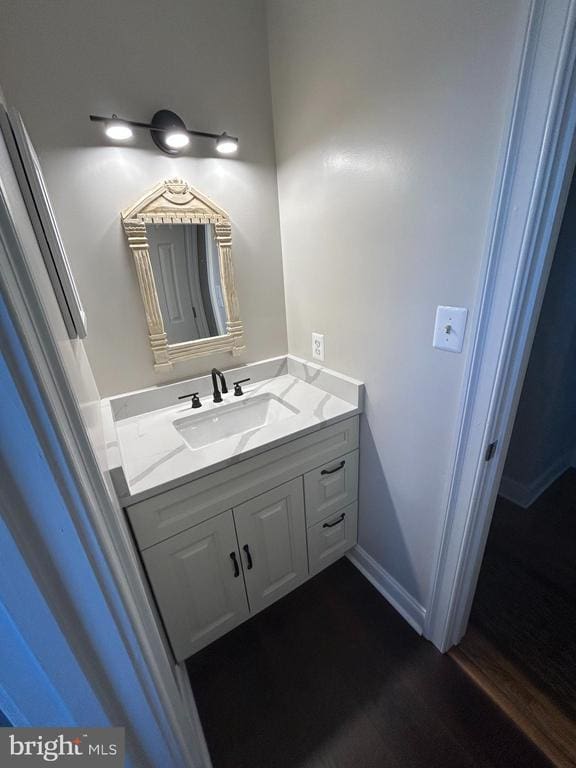  - bathroom featuring vanity and wood finished floors