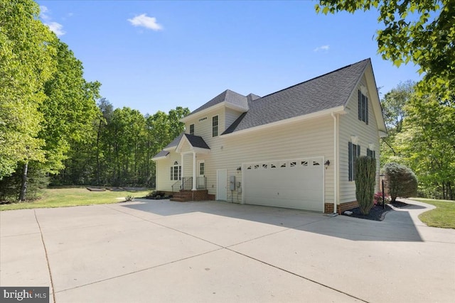 8606 Laroque Run Dr, Fredericksburg, VA 22407 - view of side of property with driveway, a shingled roof, and a garage