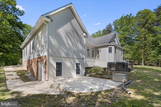 8606 Laroque Run Dr, Fredericksburg, VA 22407 - rear view of property featuring a yard, a hot tub, brick siding, and a patio