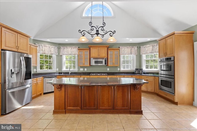 8606 Laroque Run Dr, Fredericksburg, VA 22407 - kitchen with a sink, stainless steel appliances, dark stone countertops, a center island, and glass insert cabinets