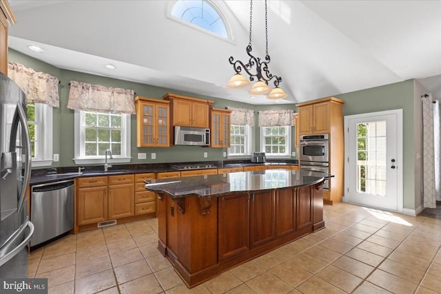 8606 Laroque Run Dr, Fredericksburg, VA 22407 - kitchen with a sink, lofted ceiling, a center island, glass insert cabinets, and appliances with stainless steel finishes