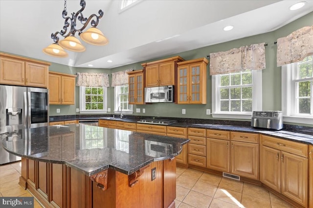 8606 Laroque Run Dr, Fredericksburg, VA 22407 - kitchen with light tile patterned floors, glass insert cabinets, a center island, a sink, and stainless steel appliances
