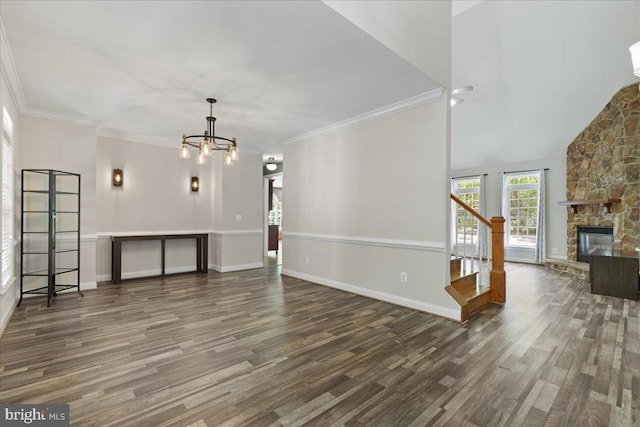8606 Laroque Run Dr, Fredericksburg, VA 22407 - unfurnished living room featuring wood finished floors, baseboards, stairway, a notable chandelier, and a stone fireplace