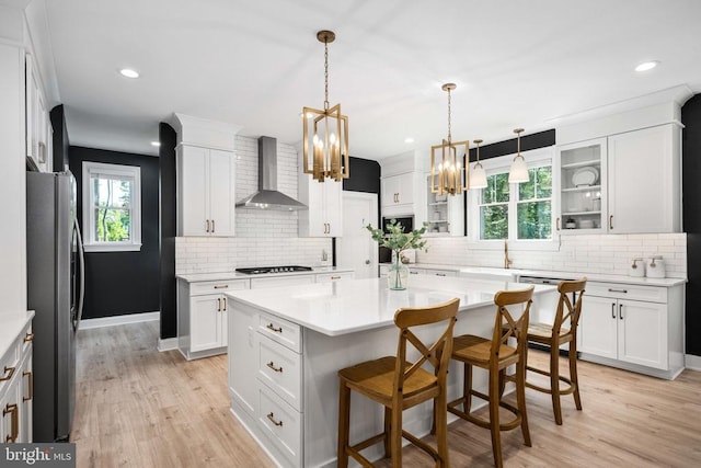 11302 Radcliff Ter, Spotsylvania, VA 22551 - kitchen with wall chimney range hood, freestanding refrigerator, white dishwasher, a chandelier, and stovetop