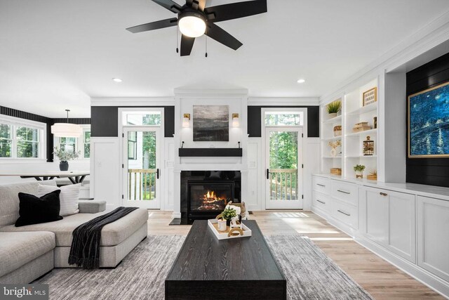 11302 Radcliff Ter, Spotsylvania, VA 22551 - living area with light wood-type flooring, a fireplace with flush hearth, plenty of natural light, ornamental molding, and ceiling fan