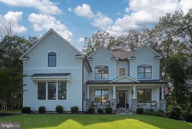 11302 Radcliff Ter, Spotsylvania, VA 22551 - view of front of house featuring a standing seam roof, a front lawn, a porch, and board and batten siding