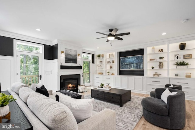 11302 Radcliff Ter, Spotsylvania, VA 22551 - living area with light wood finished floors, ceiling fan, a glass covered fireplace, and recessed lighting