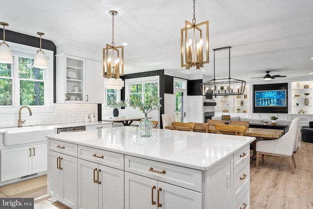 11302 Radcliff Ter, Spotsylvania, VA 22551 - kitchen featuring a chandelier, open floor plan, a kitchen island, white cabinetry, and ceiling fan
