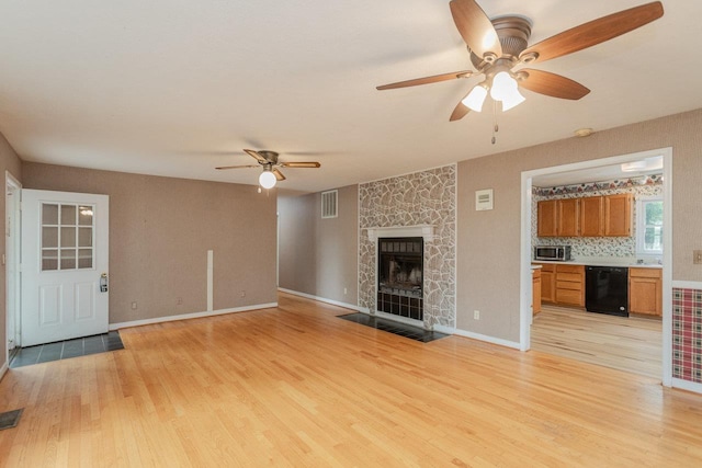 22 Loblolly Rd, Palmyra, VA 22963 - unfurnished living room featuring a ceiling fan, light wood-style floors, and a fireplace