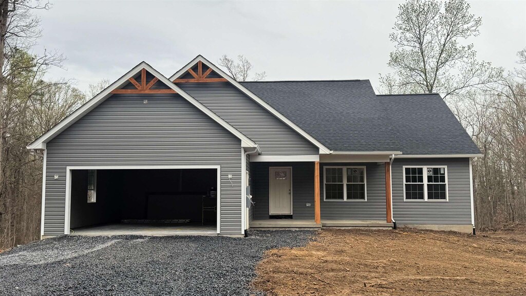 412 Secession Ln, New Market, VA 22844 - view of front of home with driveway, a porch, roof with shingles, and an attached garage