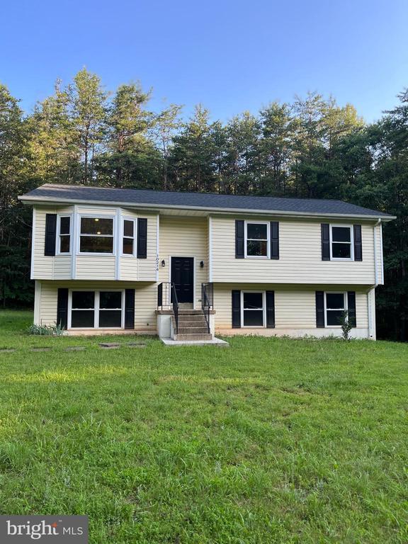 10214 Unique Trl, Rixeyville, VA 22737 - bi-level home featuring a front yard and view of scattered trees