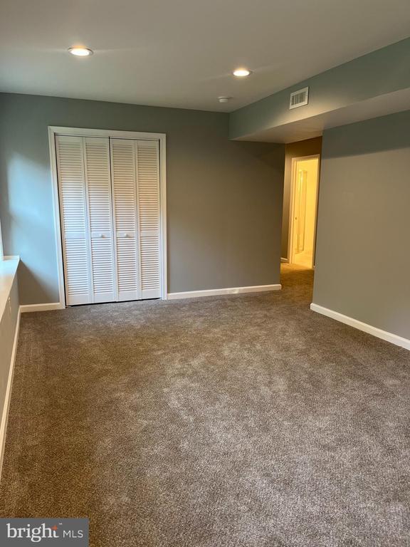 10214 Unique Trl, Rixeyville, VA 22737 - unfurnished bedroom with carpet, a closet, and recessed lighting