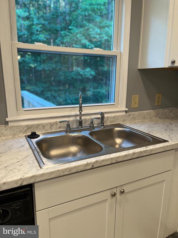 10214 Unique Trl, Rixeyville, VA 22737 - kitchen view of white cabinetry, dishwasher, and light countertops
