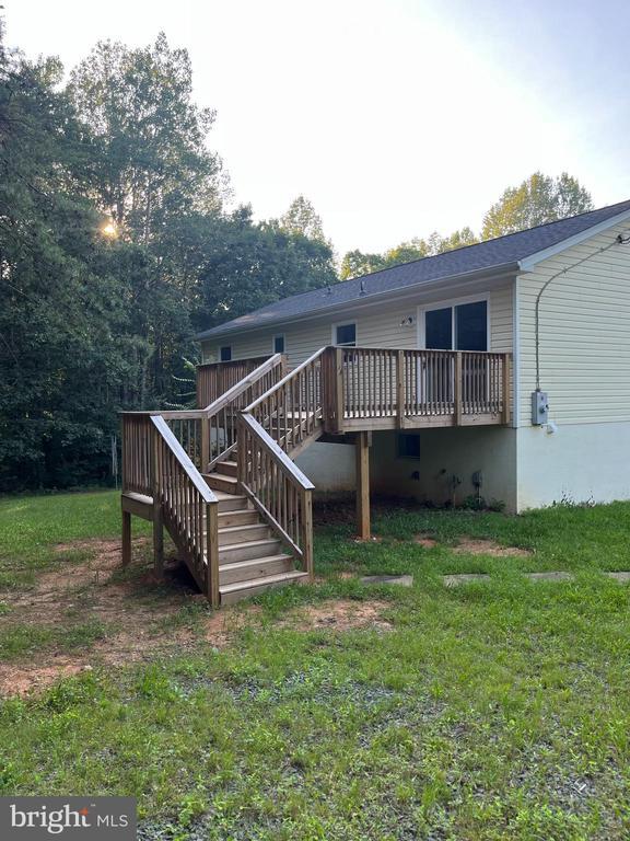 10214 Unique Trl, Rixeyville, VA 22737 - back of house featuring a deck, stairs, and a lawn