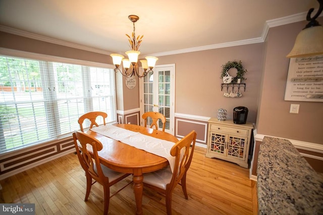 5003 Strauss Ct, Fredericksburg, VA 22407 - dining room featuring a chandelier, light wood-style floors, ornamental molding, and a wainscoted wall
