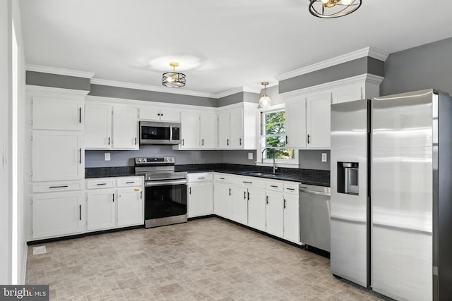 6 Charles St, Luray, VA 22835 - kitchen with stainless steel appliances, white cabinetry, dark countertops, ornamental molding, and hanging light fixtures