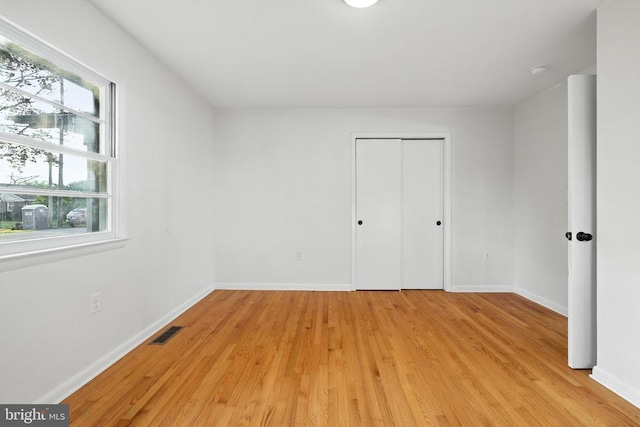6 Charles St, Luray, VA 22835 - unfurnished bedroom featuring multiple windows, light wood-type flooring, and a closet