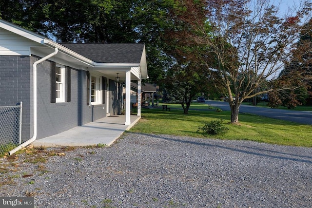 6 Charles St, Luray, VA 22835 - view of home's exterior with brick siding, a yard, roof with shingles, and covered porch
