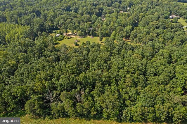 - aerial view of property's location with a heavily wooded area