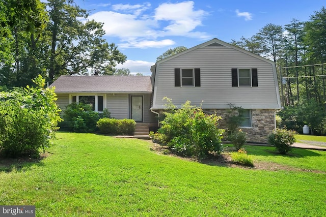  - split level home with stone siding and a front lawn