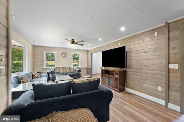  - living room featuring light wood-style floors, wooden walls, a ceiling fan, and recessed lighting