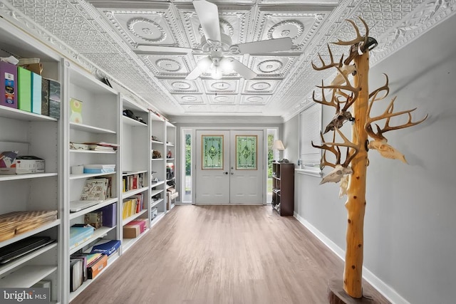  - foyer entrance with an ornate ceiling, wood finished floors, and ceiling fan