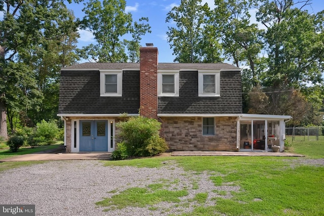  - view of front of home with a chimney, a shingled roof, stone siding, and french doors
