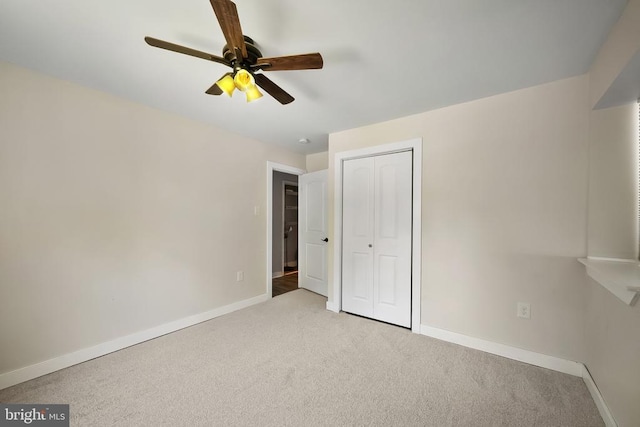 - unfurnished bedroom featuring carpet floors, a closet, and a ceiling fan