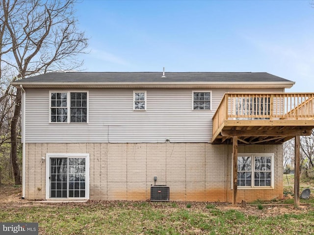 rear view of house featuring a wooden deck, central AC, and brick siding