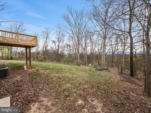 view of yard featuring a deck and cooling unit