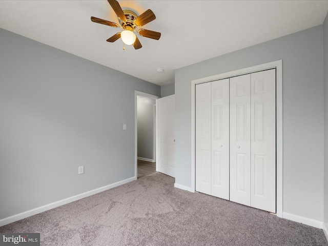 unfurnished bedroom with baseboards, carpet flooring, a closet, and a ceiling fan