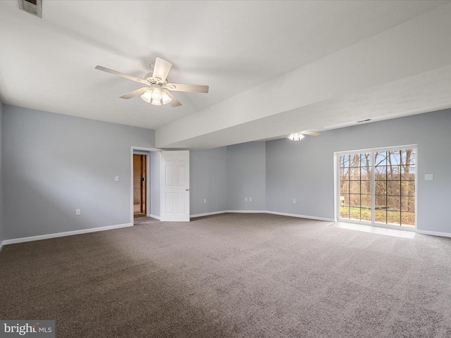 carpeted spare room with a ceiling fan, baseboards, and visible vents
