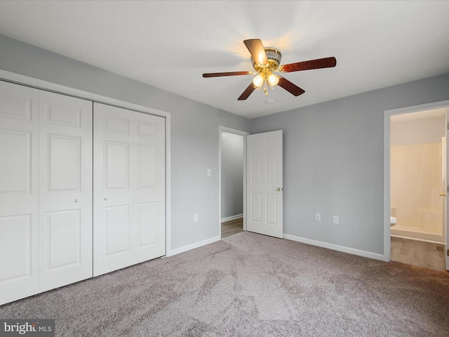 unfurnished bedroom featuring carpet, baseboards, and a closet